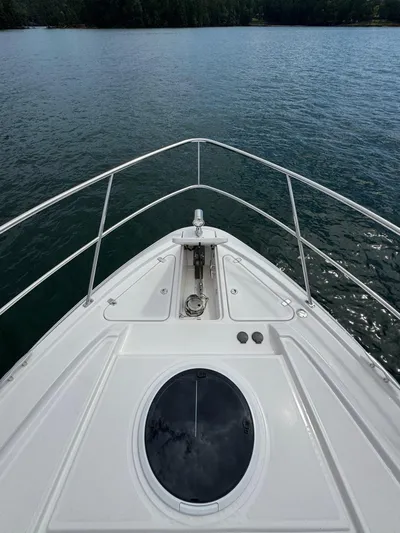 Lake Break Yacht Photos Pics Bow view of 2016 Regal 42 Sport Coupe on calm water.