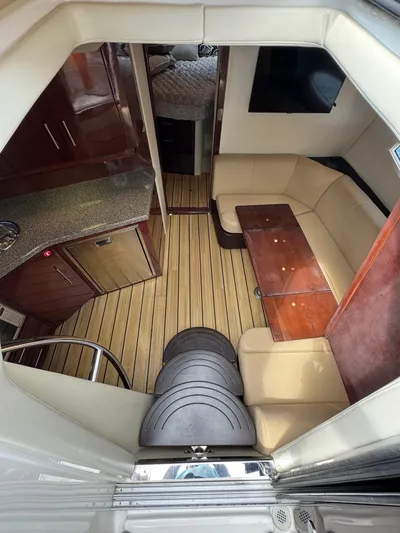 Lake Break Yacht Photos Pics Interior of 2016 Regal 42 Sport Coupe with seating, table, and kitchenette.