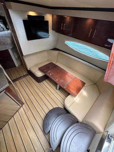 Lake Break Yacht Photos Pics Interior of 2016 Regal 42 Sport Coupe with leather seating and wooden table.