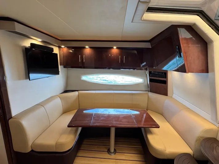 Lake Break Yacht Photos Pics Luxurious interior of 2016 Regal 42 Sport Coupe with leather seating and wooden table.