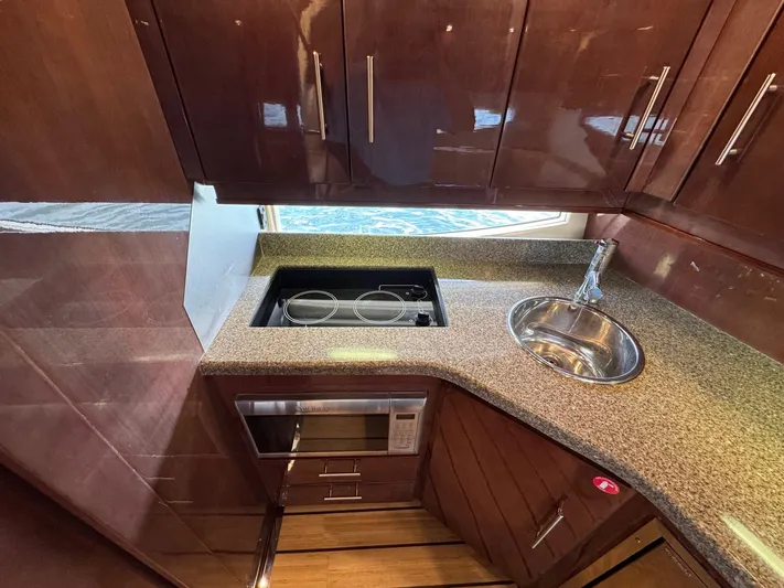 Lake Break Yacht Photos Pics Luxurious galley in 2016 Regal 42 Sport Coupe with modern appliances and sleek cabinetry.