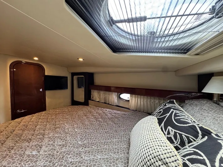 Lake Break Yacht Photos Pics Luxurious interior of 2016 Regal 42 Sport Coupe with skylight and elegant bedding.