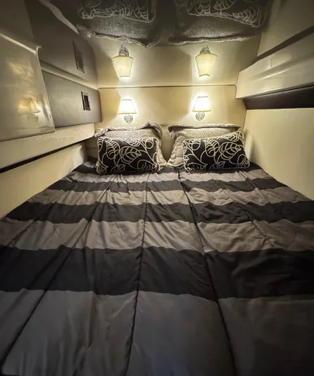 Lake Break Yacht Photos Pics Luxurious cabin interior of 2016 Regal 42 Sport Coupe with cozy bedding and ambient lighting.