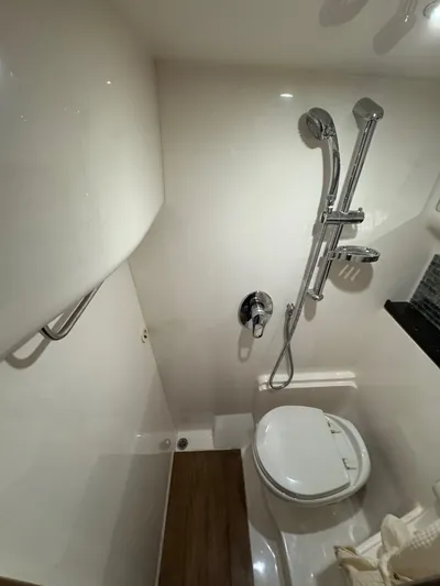 Lake Break Yacht Photos Pics Bathroom interior of 2016 Regal 42 Sport Coupe yacht, featuring shower and toilet.