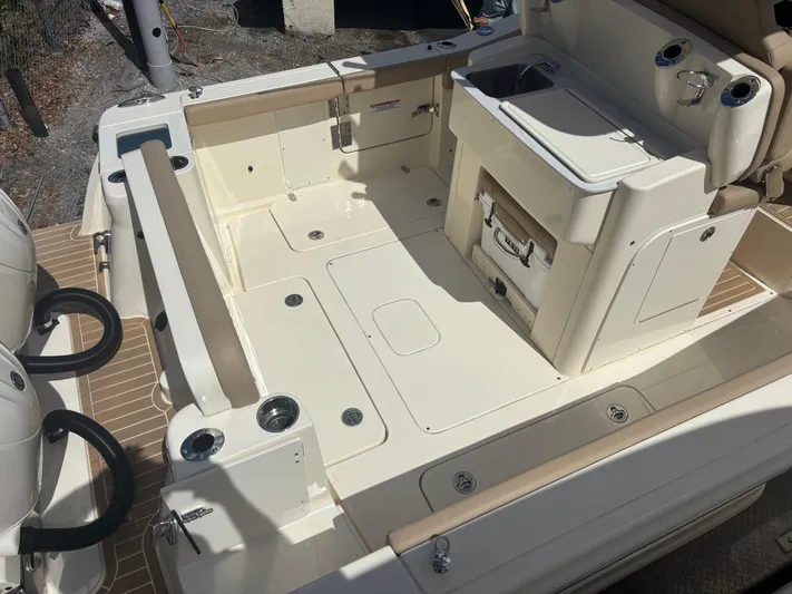  Yacht Photos Pics 2025 Scout 277 LXF boat deck with seating and storage compartments.