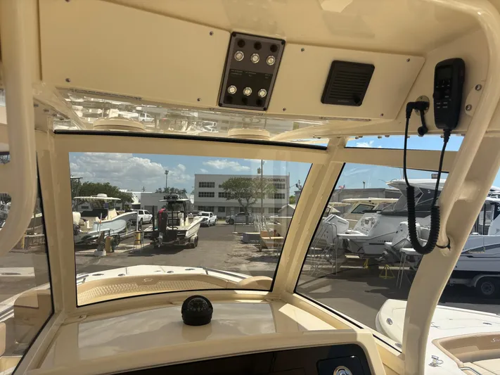  Yacht Photos Pics Interior view of 2025 Scout 277 LXF boat, showcasing dashboard and marina background.