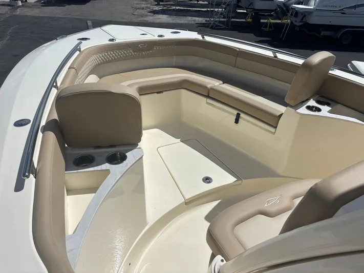  Yacht Photos Pics 2025 Scout 277 LXF boat interior with beige seating and cup holders.