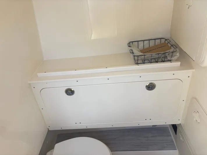  Yacht Photos Pics 2025 Scout 277 LXF boat interior with storage and toilet.