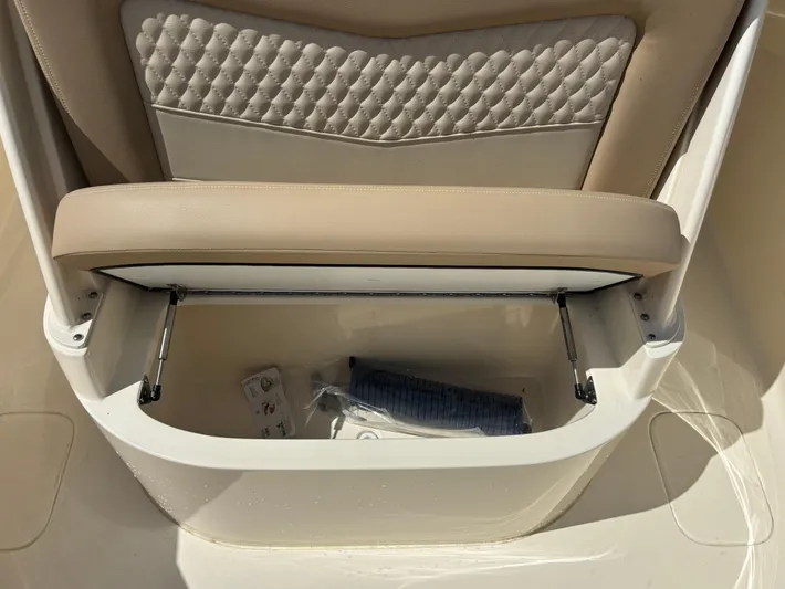  Yacht Photos Pics 2025 Scout 277 LXF boat seat with storage compartment open.
