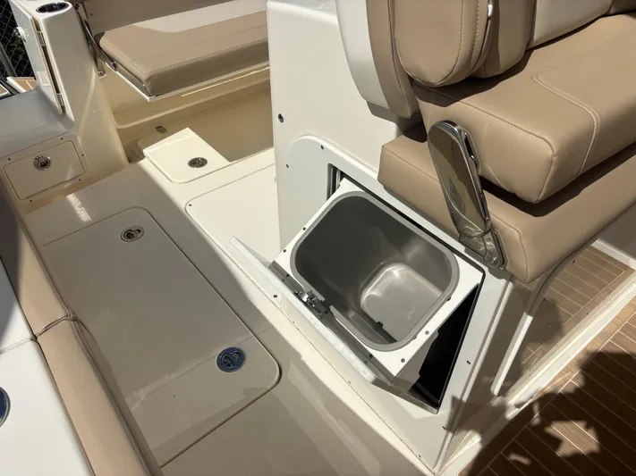  Yacht Photos Pics 2025 Scout 277 LXF boat interior with seating and storage compartment.