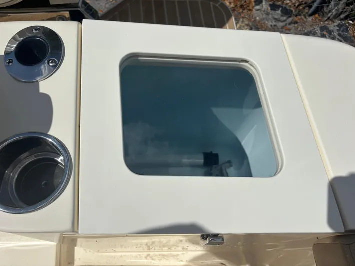  Yacht Photos Pics 2025 Scout 277 LXF boat detail with cup holders and storage compartment.