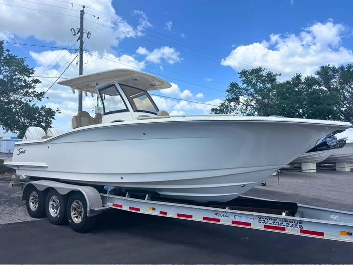  Yacht Photos Pics 2025 Scout 277 LXF boat on trailer under blue sky.
