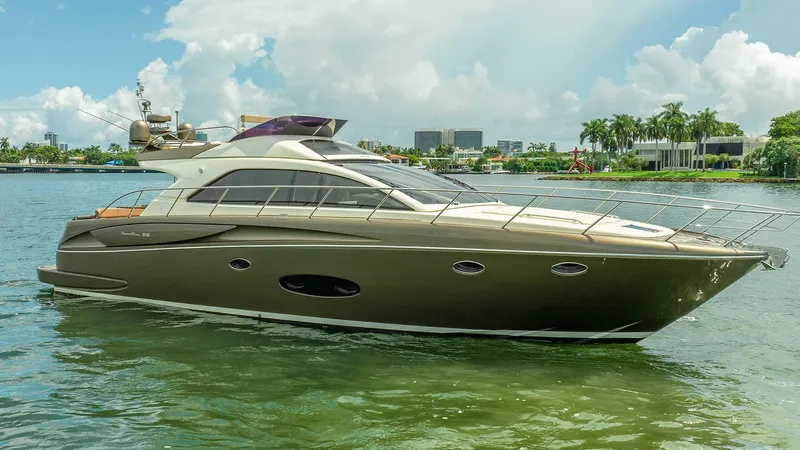 Gabriela Yacht Photos Pics 2012 Riva Sport 56 yacht on calm water, with a scenic city backdrop.