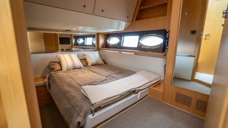 Gabriela Yacht Photos Pics Luxurious cabin interior of 2012 Riva Sport 56 yacht with cozy bed and porthole windows.