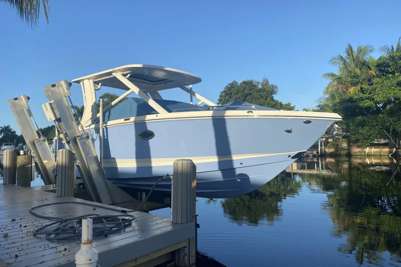  Yacht Photos Pics 2022 Chaparral 280 OSX boat docked on a sunny day by the water.