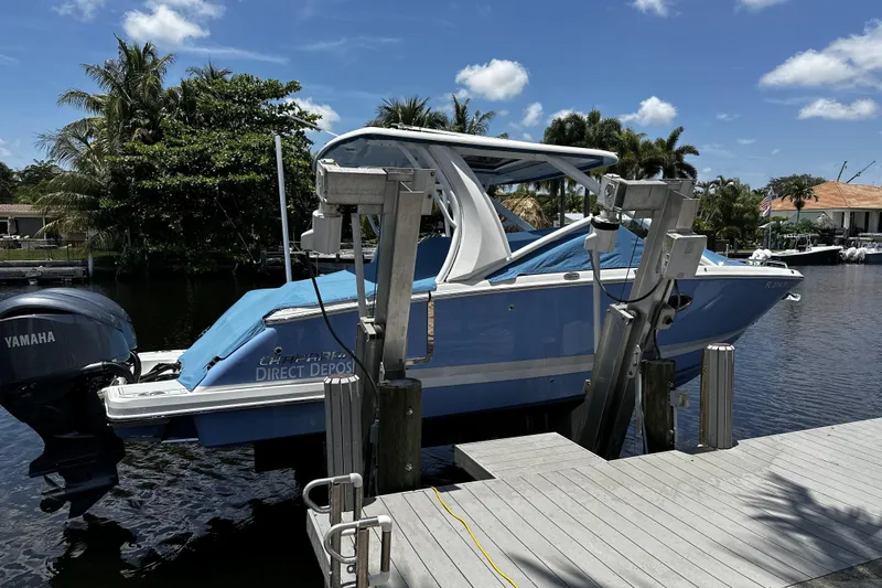  Yacht Photos Pics 2022 Chaparral 280 OSX boat docked, featuring Yamaha outboard motor, surrounded by tropical scenery.
