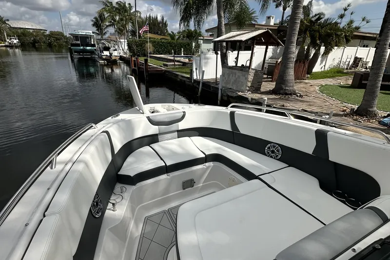  Yacht Photos Pics 2022 Chaparral 280 OSX boat with spacious seating, docked by a scenic canal.