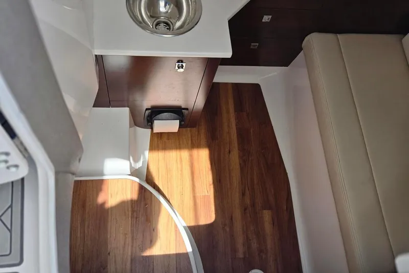  Yacht Photos Pics Interior of 2022 Chaparral 280 OSX boat with wood flooring and compact sink.