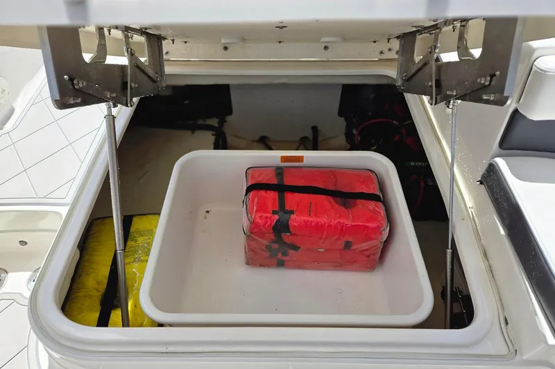  Yacht Photos Pics Storage compartment of 2022 Chaparral 280 OSX boat with safety equipment.