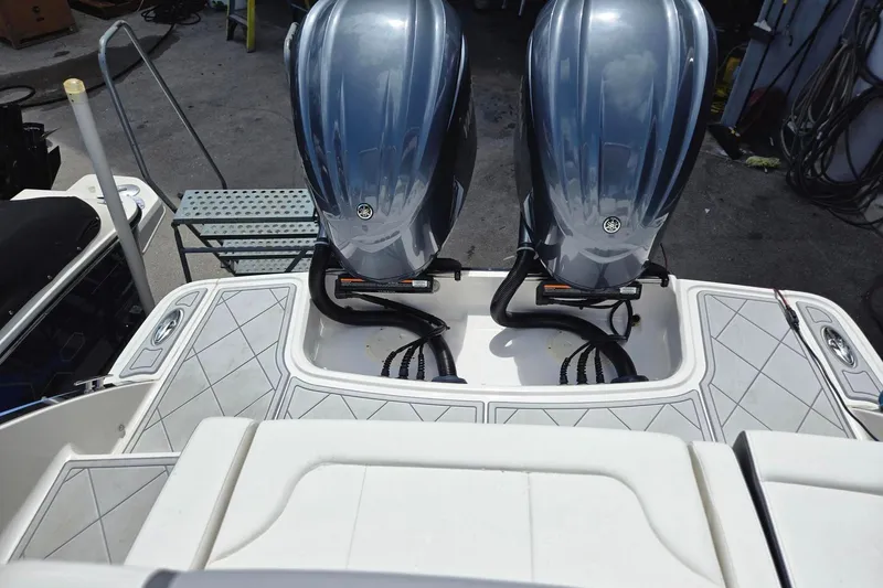  Yacht Photos Pics 2022 Chaparral 280 OSX boat with dual outboard engines, rear deck view.