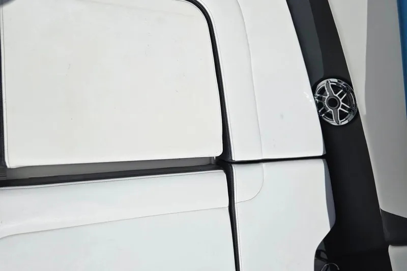  Yacht Photos Pics 2022 Chaparral 280 OSX boat interior with white seating and speaker detail.