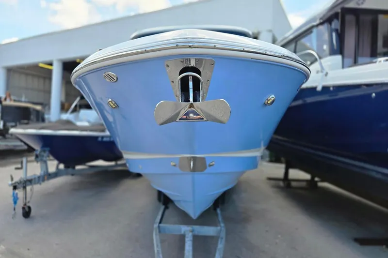  Yacht Photos Pics 2022 Chaparral 280 OSX boat, blue hull, displayed in a marina setting.