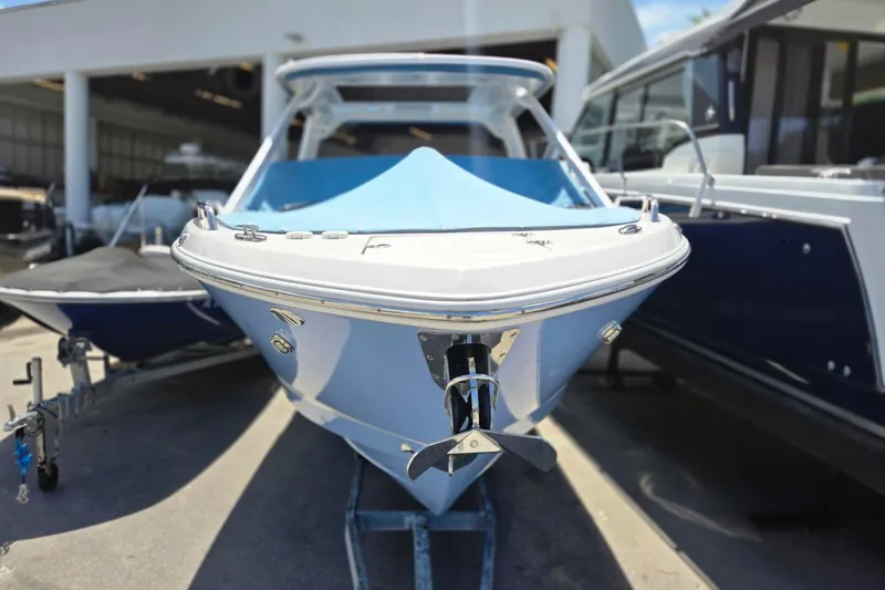  Yacht Photos Pics 2022 Chaparral 280 OSX boat displayed in a showroom, front view.