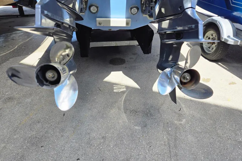  Yacht Photos Pics 2022 Chaparral 280 OSX boat propellers on a trailer, showcasing dual outboard motors.