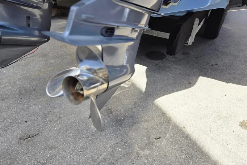  Yacht Photos Pics Close-up of a 2022 Chaparral 280 OSX boat propeller on concrete surface.