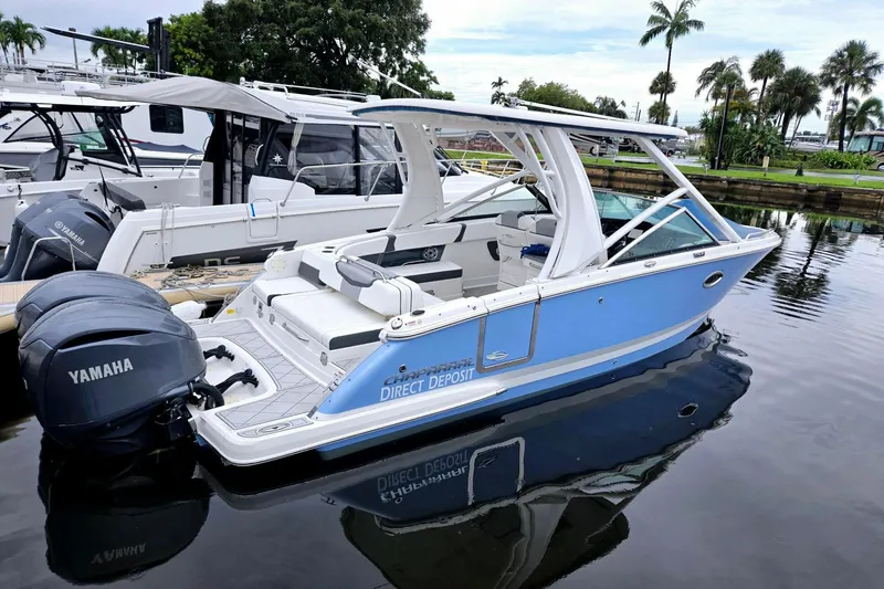  Yacht Photos Pics 2022 Chaparral 280 OSX boat docked, featuring Yamaha engines, sleek design, and blue exterior.