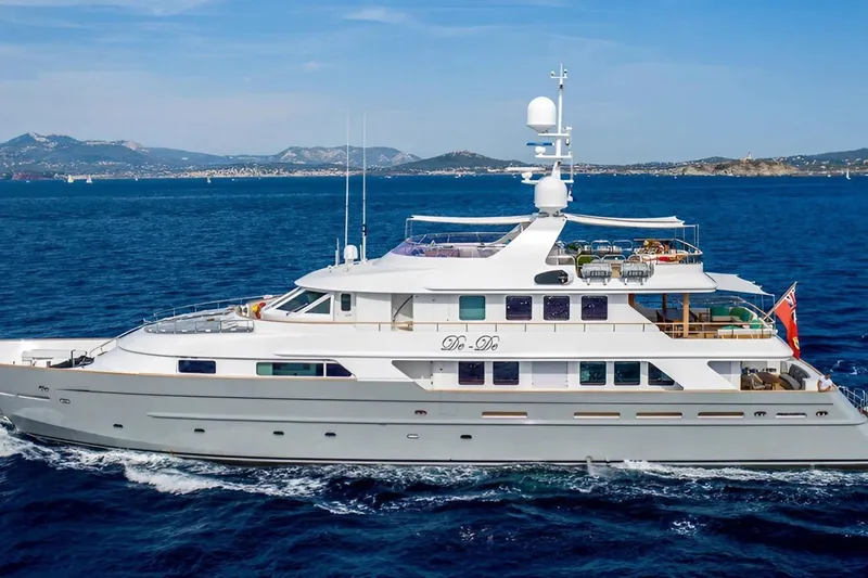  Yacht Photos Pics Luxurious 2002 CMN Custom yacht cruising on blue ocean with scenic coastline.