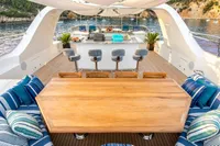 Luxurious yacht deck with seating, bar stools, and scenic ocean view, CMN Custom 2002 model.