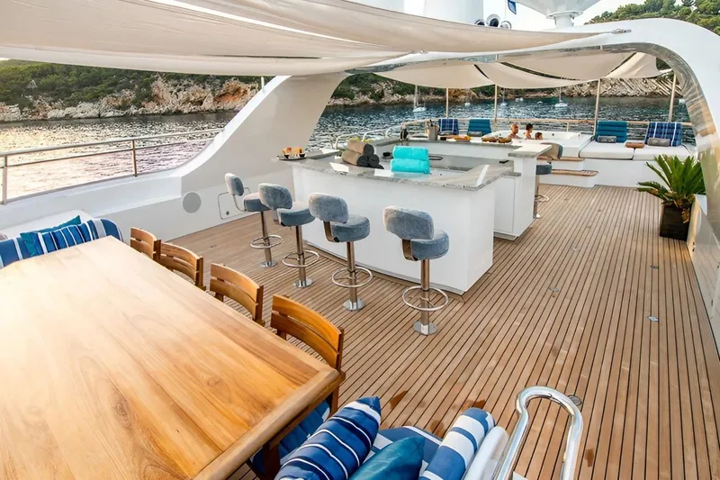  Yacht Photos Pics Luxurious yacht deck with bar, seating, and ocean view, CMN Custom 2002 model.