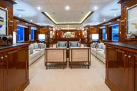 Luxurious yacht interior with elegant wood paneling, plush seating, and ambient lighting, CMN Custom 2002.