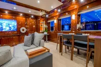 Luxurious yacht interior with elegant wood paneling, modern furniture, and ambient lighting, CMN Custom 2002.