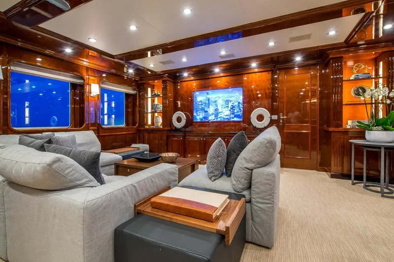  Yacht Photos Pics Luxurious yacht interior with plush seating, wood paneling, and large TV, CMN Custom 2002 model.