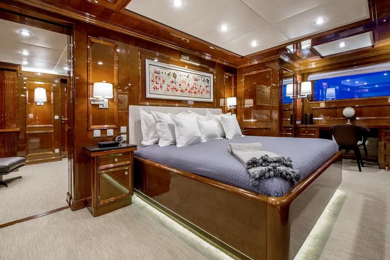 Yacht Photos Pics Luxurious yacht bedroom with elegant wood paneling, plush bedding, and ambient lighting, CMN Custom 2002.