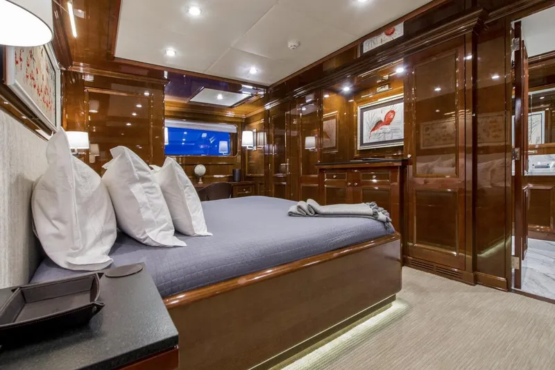  Yacht Photos Pics Luxurious yacht bedroom with elegant wood paneling, modern lighting, and stylish decor, CMN Custom 2002.