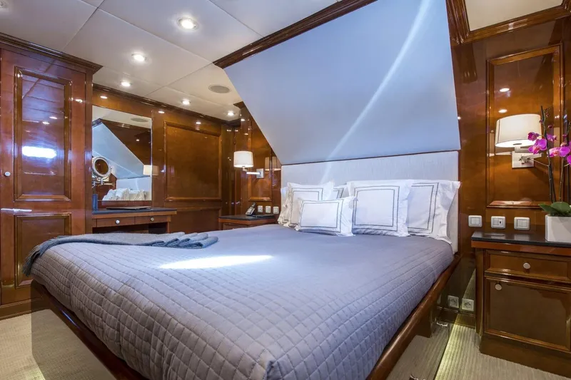  Yacht Photos Pics Luxurious yacht bedroom with elegant wood paneling, soft lighting, and plush bedding, CMN Custom 2002.