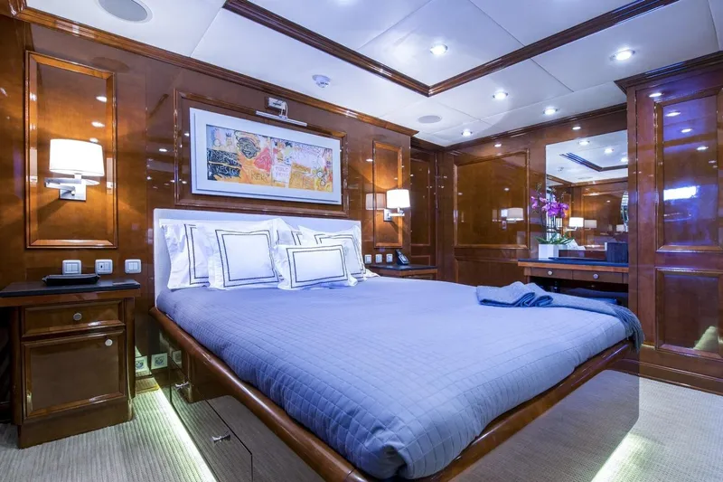  Yacht Photos Pics Luxurious yacht bedroom with wood paneling, modern lighting, and elegant bedding, CMN Custom 2002.