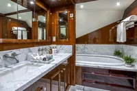 Luxurious yacht bathroom with marble countertops and bathtub, CMN Custom 2002 model.