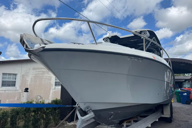  Yacht Photos Pics 2006 Hydra-Sports Vector 3300 VX boat on trailer, under a partly cloudy sky.