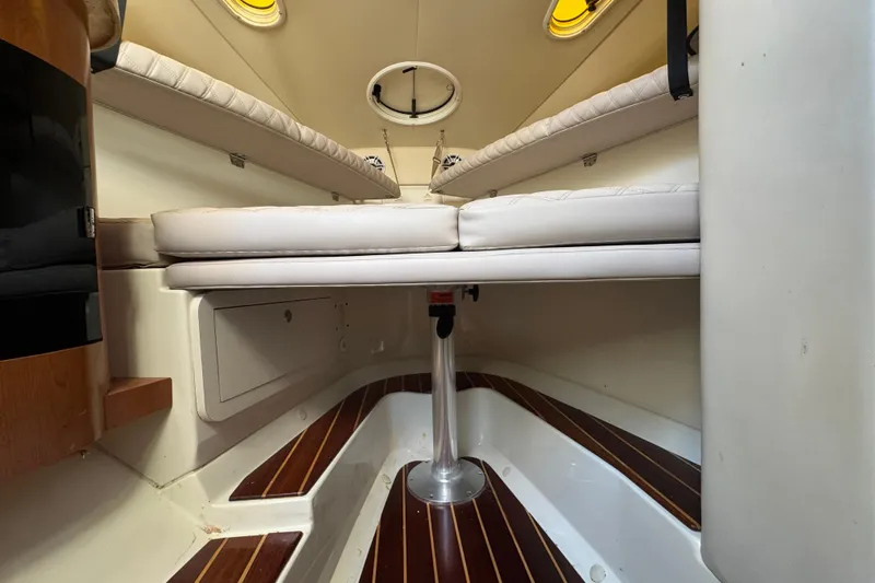  Yacht Photos Pics Interior cabin of 2006 Hydra-Sports Vector 3300 VX with cushioned seating and wood flooring.