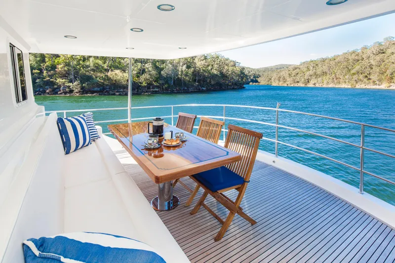  Yacht Photos Pics Luxurious 2013 Nordhavn 68 yacht deck with dining area overlooking serene waters.