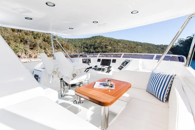  Yacht Photos Pics Luxurious 2013 Nordhavn 68 yacht cockpit with seating, table, and scenic view.