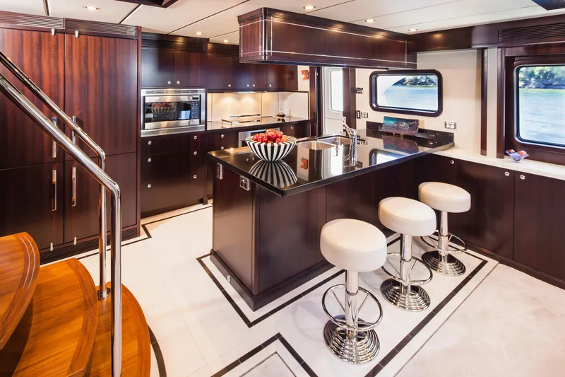  Yacht Photos Pics Luxurious kitchen interior of 2013 Nordhavn 68 yacht with modern design and elegant finishes.
