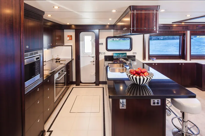  Yacht Photos Pics Luxurious kitchen interior of 2013 Nordhavn 68 yacht with modern appliances and ocean view.
