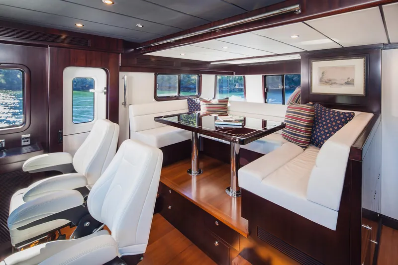  Yacht Photos Pics Luxurious interior of 2013 Nordhavn 68 yacht with white seating and elegant wood finishes.