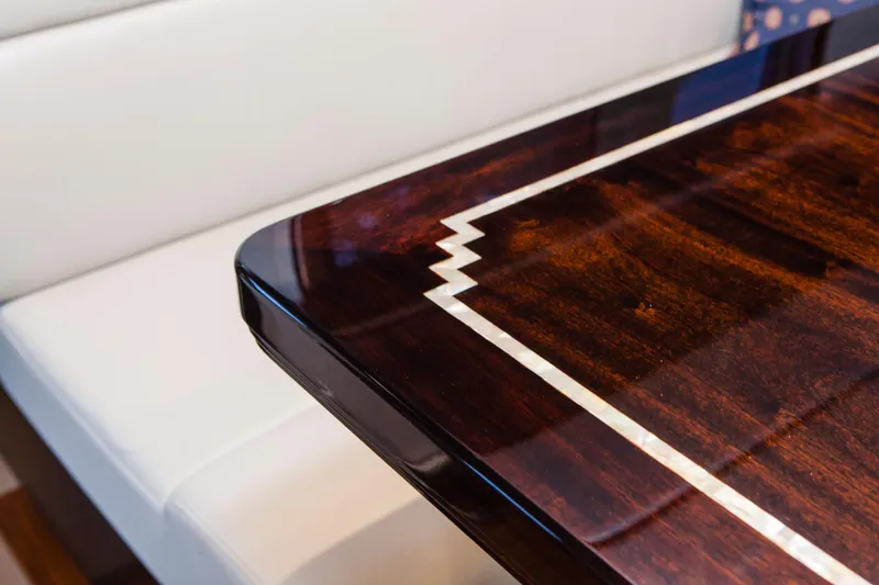  Yacht Photos Pics Luxurious wooden table with intricate inlay design on Nordhavn 68 yacht, 2013 model.