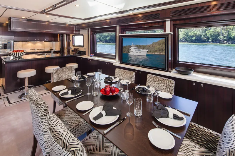  Yacht Photos Pics Luxurious dining area on a 2013 Nordhavn 68 yacht with elegant table setting.